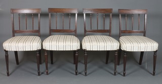 A set of 4 Sheraton style mahogany dining chairs, 19th Century, with tablet cresting rails above foliate carved and reeded spindle  backs, foliate woven stuff-over seats and raised on turned tapered  reeded legs