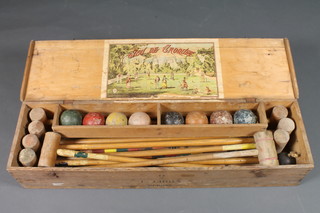 A childs 19th Century French croquet set comprising 9 mallets,  8 balls and a collection of hoops