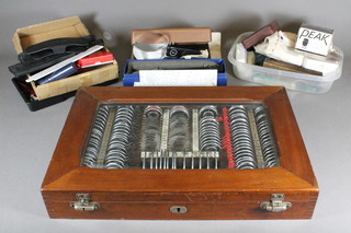 A cased set of mid 20th Century opticians sample lenses and  sundry opticians equipment
