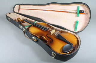 A facsimile Stradivarius violin labelled Fecit Anno 1701 with  14.5" back, complete with bow and in fibre carrying case