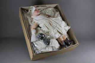 A 19th Century porcelain headed doll, f, and a collection of  various fabrics
