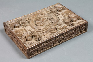A Chinese carved hardwood box with hinged lid decorated a  dragon 12"