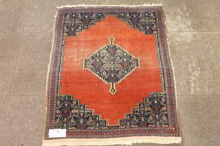 A small Persian red ground rug, having central floral mihrab to a  quartered field, multi bordered and fringed 43"l x 31"w