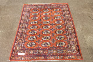 An Afghan red ground Bokhara carpet, the geometric field decorated with 3 rows of 8 elephant pad motifs, multi bordered  and fringed 68"l x 52"w