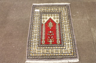 A Turkish prayer rug, the directional field centred with a colonnade decorated an urn of flowers, multi bordered and  fringed, 50"l x 31"w