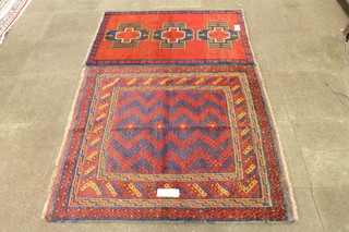 A Caucasian rug with geometric blue and red ground field  decorated chevrons, multi bordered and fringed 53"l x 50"w and  1 other red ground rug