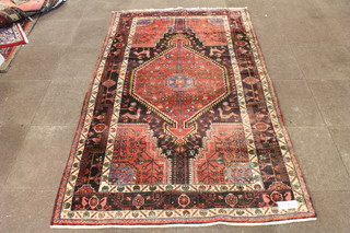 A red and brown ground Caucasian carpet, the geometric  quartered field decorated stylised animals and flowers, multi  bordered with cropped fringe to end, 94"l x 55"w
