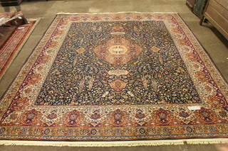 A North West Persian style blue ground Wilton carpet with an intricate foliate field, centred with a lobed motif, multi bordered  and fringed, 128"l x 109"w