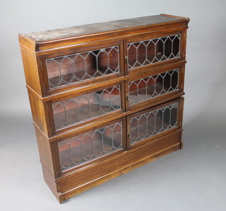 A Globe Wernicke style 3 tier oak bookcase enclosed by lead  glazed doors 46"w x 12"d x 44"h