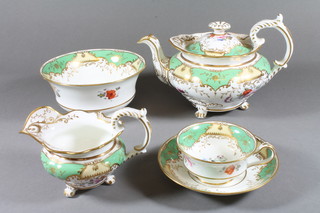 A 42 piece Rockingham style tea service with green and gilt  ground, floral decoration comprising 2 plates 9.5" - 1 f and r,  teapot - cracked, teapot stand 7.5", sucrier and cover, slop bowl -  cracked, cream jug - cracked, 12 large tea cups, 12 small cups -  1 cracked, 12 saucers, together with a 19 piece Royal Crown  Clarence pattern tea service decorated buildings
