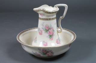 A pottery jug and bowl with rose decoration