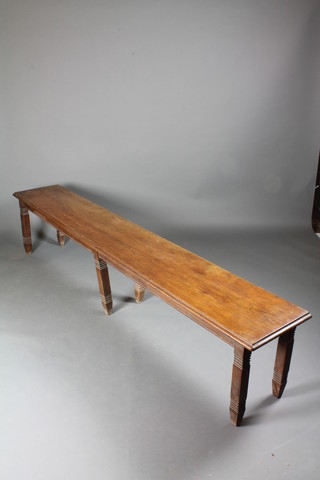 A late 19th Century Continental oak bench with moulded top on reeded tapered legs 19"h x 91.5"w x 16"d