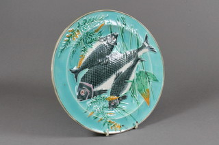 A 19th Century Wedgwood Majolica plate decorated fish,  cracked, the reverse impressed Wedgwood GNL, 9" diam.