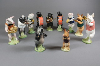 A set of 11 Beswick Pottery Pig Promenade Figures comprising, James Triangle PP7, John The Conductor PP1, David Flautist  PP3, Christopher Guitar PP9, Richard French Horn PP8, 2 x  Andrew Cymbal PP4, Matthew Trumpeter PP2, Daniel Violinist  PP5 and 2 x Michael Drum PP6, all boxed
