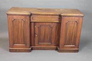 A Victorian walnut inverted breakfront sideboard fitted a central  frieze drawer above a cupboard door, flanked by a pair of fielded  panelled cupboard doors enclosing linen drawers, raised on a  plinth base 34"h x 60"w x 18/5"d
