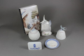 A Lladro table sign 3", a Lladro Society scroll decorated a dove  5", a 1992 sphere decorated Sportsman, a circular dish decorated  a galleon, a bell and together with a 2003/2004 Lladro  Authorised Reference Guide