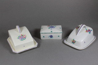 A rectangular Poole Pottery jar and cover with floral decoration 4.5", and 2 wedge shaped floral pattern Poole Pottery butter  dishes 5.5"