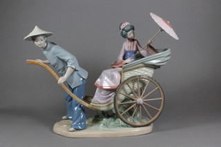 A Lladro figure group of a seated lady in a rickshaw 13"