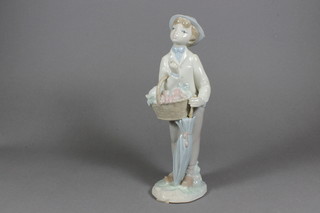 A Lladro figure of a standing boy with umbrella and basket of fruit 9.5", umbrella f,