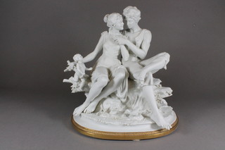 A Parian figure group of a seated lady and gentleman, on an oval base 11"