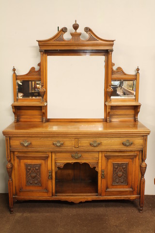 An Edwardian carved walnut mirror backed sideboard fitted shelves above 2 long and 1 short drawers above a recess, flanked   by cupboards, raised on turned supports 82"h x 59"w x 19.5"d