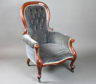 A Victorian mahogany show frame armchair upholstered in blue material, raised on cabriole supports