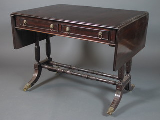 A 19th Century mahogany sofa table fitted 2 frieze drawers with opposing faux fronted drawers, raised on acanthus leaf carved  supports and reeded swept legs united by turned stretchers 29"h x  60"w x 27"d