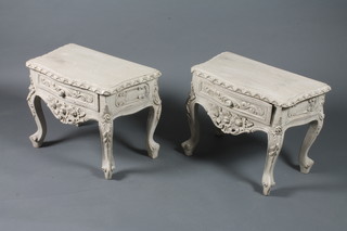 A pair of Louis XV style cream painted low tables with foliate  relief carved decoration on cabriole legs and scroll feet 18"h x  24"w x 14"d