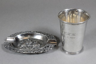 A French silver beaker of waisted form and an embossed French  silver ashtray