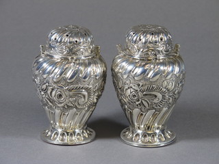 A pair of Victorian embossed silver sugar sifters, London 1885  by Rosenthal, Jacob & Co