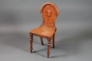 A Victorian oak hall chair, the oval back centred with shield cartouche above a solid seat on turned legs