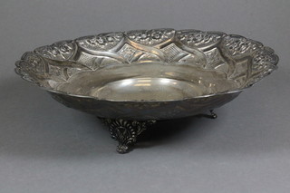 A circular embossed Continental silver dish, raised on 3 panel supports 10 ozs