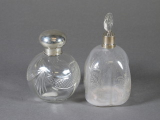 A cut glass dressing table jar with silver collar and a Dutch style blown and etched glass perfume bottle with silver collar