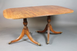 A late George III style mahogany D end extending dining table,  raised on turned column supports, reeded legs with with brass  caps and casters 39"w x 77"l