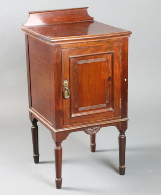 An Edwardian mahogany pot cupboard having a fielded panelled cupboard door, raised on turned tapered legs 34"h x 17"w
