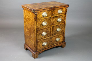 A George I style burr walnut Bachelor's chest, cross banded,  with hinged top above an arrangement of 2 long and 4 short  drawers, raised on shaped bracket feet 30"h x 25"w x 14"d
