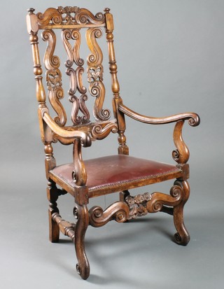 An early 19th Century Continental carved walnut elbow chair in the mid 17th Century style with S scroll carved cresting rail and  splats, over scrolled arms and a stuff over seat, raised on scroll  feet