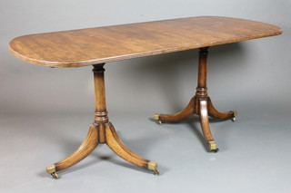 A Georgian style mahogany D end dining table, raised on ring turned tapered column supports, tripod bases with brass caps and  castors, late 19th Century 66"l x 30"w