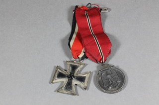 A facsimile WWII German Third Reich Iron Cross Second Class  and a West Wall medal