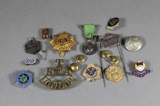 A London Royal Field Artillery Territorial shoulder title, an  Army Service Corps cap bage, an enamelled Hells Angel badge, other enamelled badges and a silver miniature medal