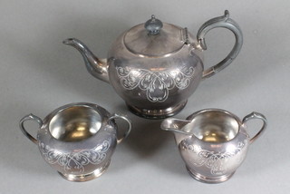 A circular engraved 3 piece silver plated tea service with teapot, twin handled sugar bowl and milk jug