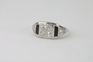 A lady's 14ct white gold dress ring set 2 panels of black onyx surrounded by diamonds