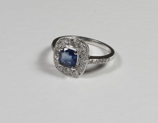 An 18ct white gold dress ring set a square sapphire surrounded  by diamonds approx 1.25/0.60ct