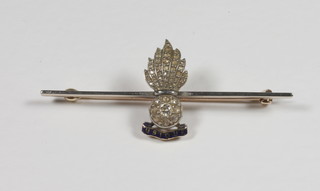 A gold and enamelled Royal Artillery sweetheart brooch in the form of a grenade set diamonds