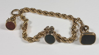 A gilt metal rope twist bracelet hung 3 seals