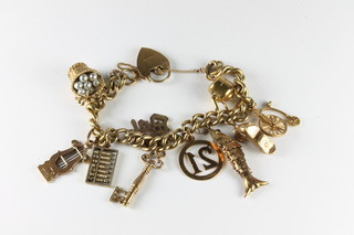 A 9ct gold charm bracelet hung 10 charms