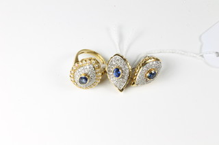 A suite of 18ct yellow gold jewellery comprising an oval shaped  dress ring set diamonds and sapphires and matching earrings