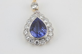 A lady's tear drop cut pendant set a tanzanite surrounded by  diamonds, approx 4ct/1.15ct