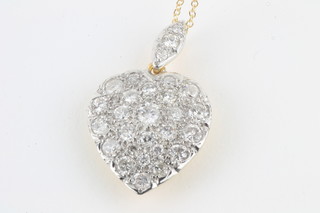 An 18ct white gold heart shaped pendant set diamonds approx  1.85ct, hung on a fine gold chain