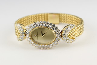 A Vacheron & Constantine lady's 18ct yellow gold cocktail wristwatch with  oval dial surrounded by diamonds ILLUSTRATED FRONT COVER